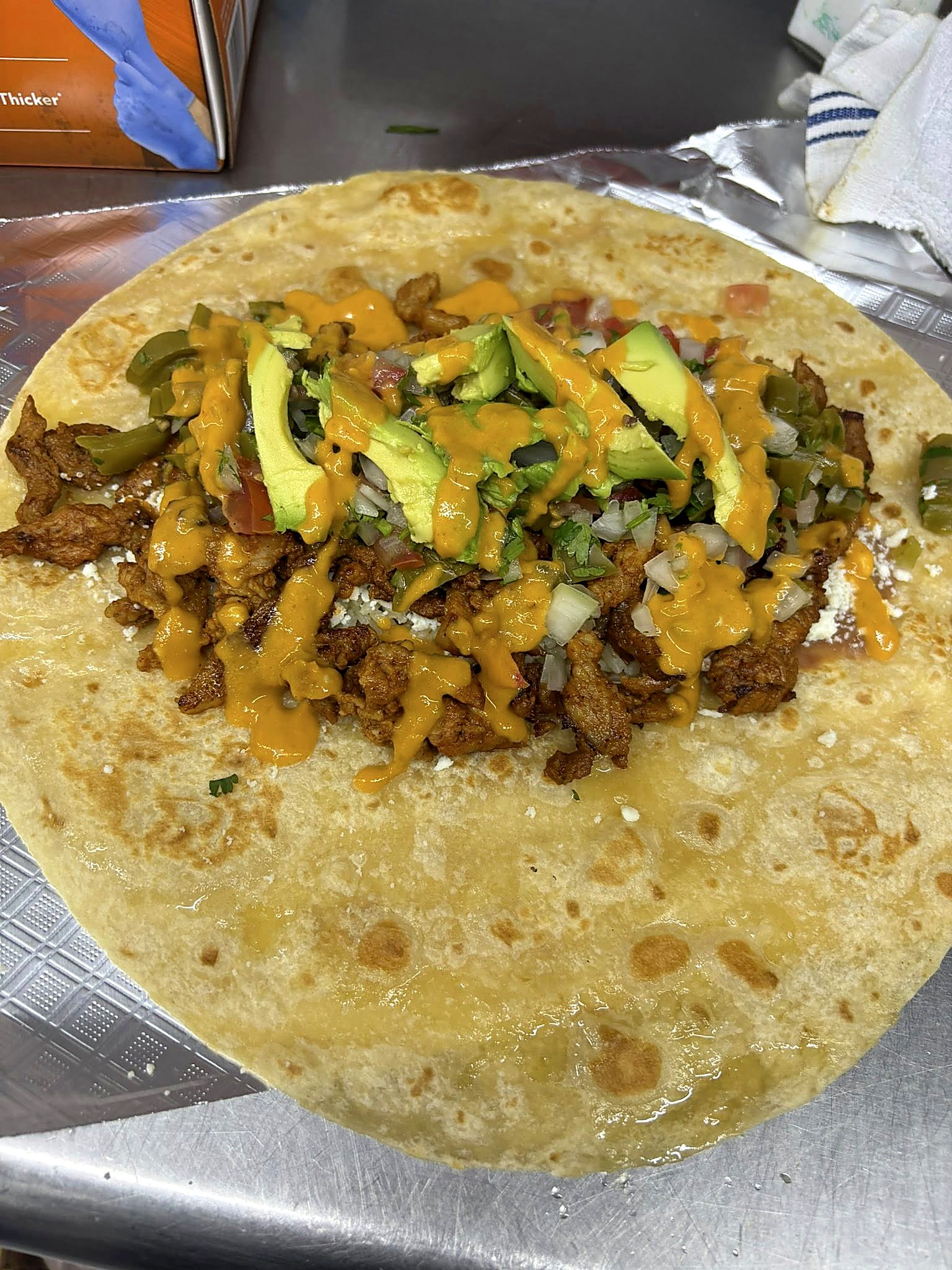 Torta with mayo, lettuce, tomato, avocado, beans, and meat